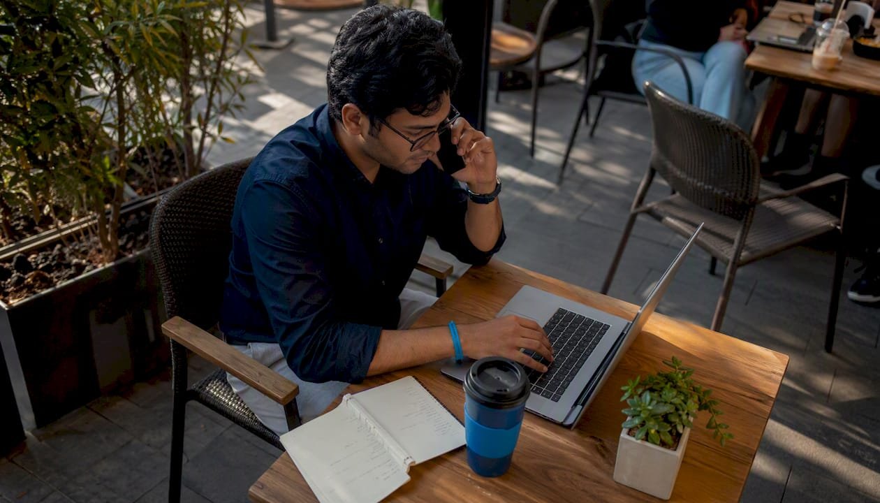 Man booking courier service online at home