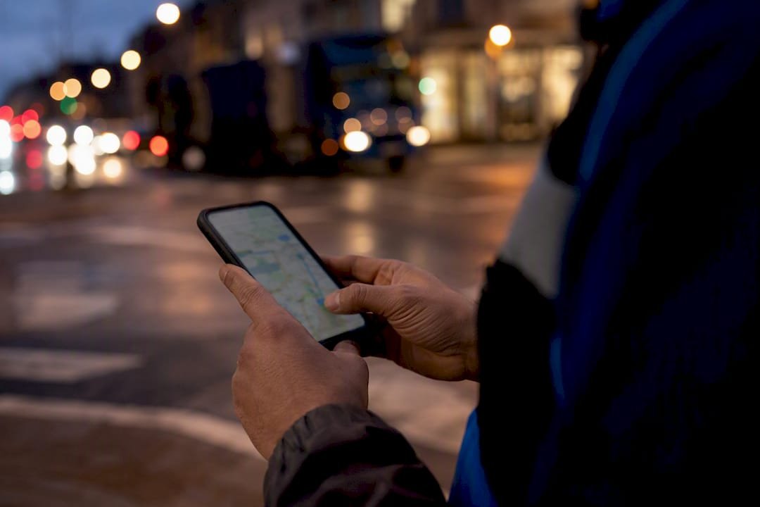 Courier manually rerouting delivery on phone