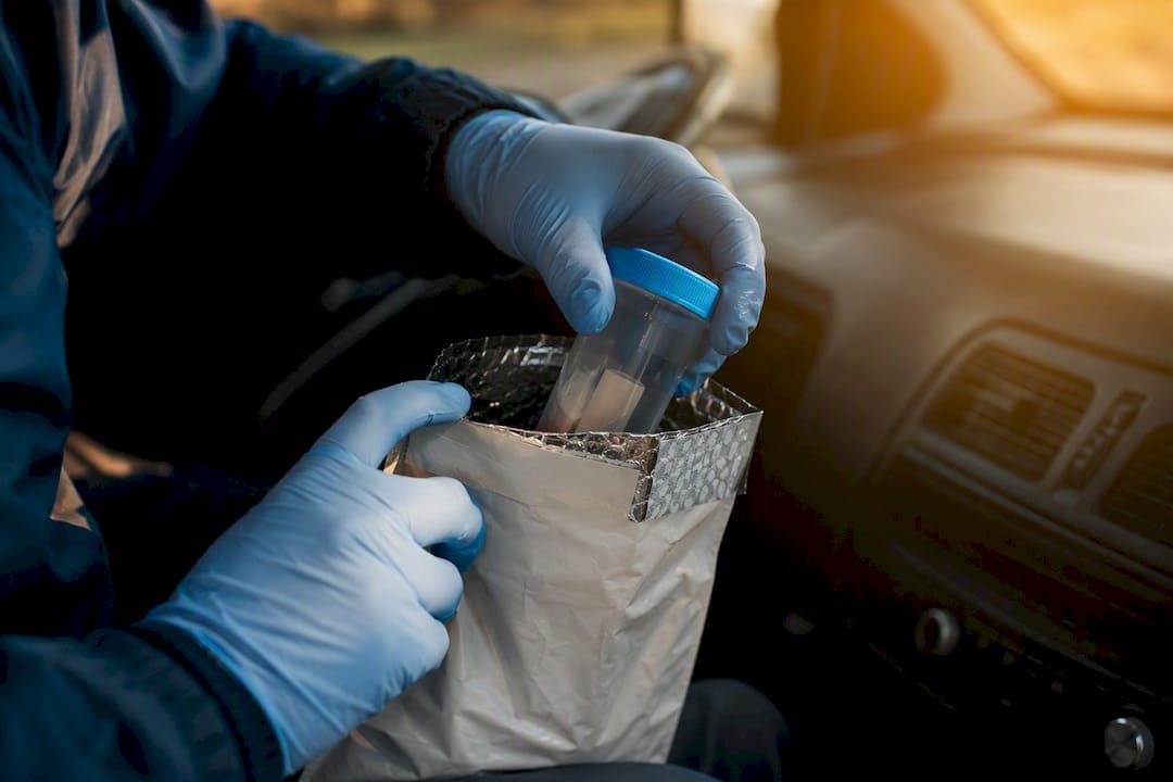 Courier handling sealed clinical specimen packaging